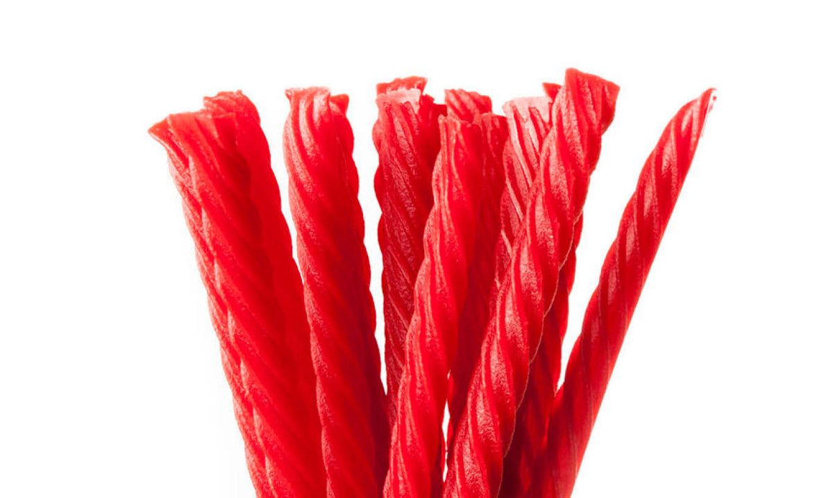 Bundle of red licorice twists on a white background