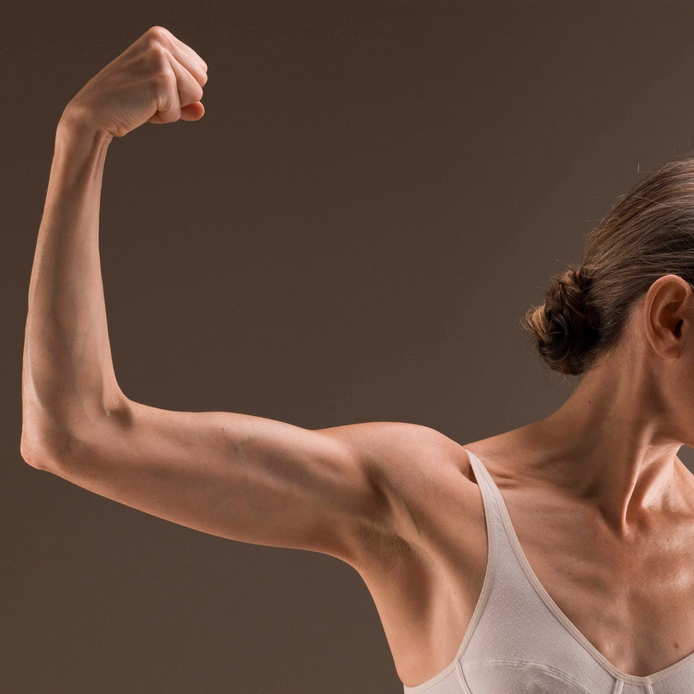 A woman flexing her arm.